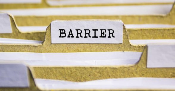 Yellow file folders filled with papers. One folder is labeled "barrier."