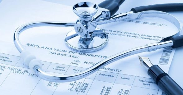 Image of a paper indicating an explanation of insurance benefits, with a stethoscope and a pen laying on to of the paper.