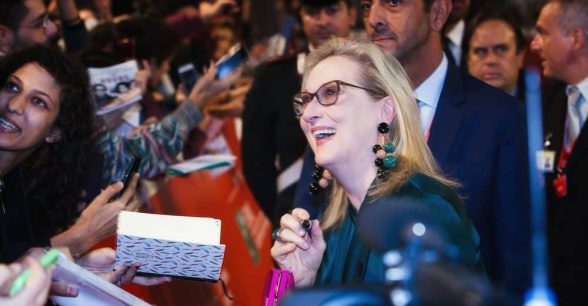 Meryl Streep signing autographs in a crowd