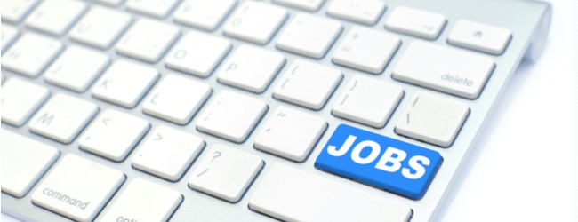 An Apple keyboard with a blue key that reads "jobs" in capital letters.