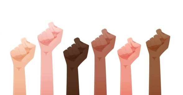 illustration of fists of people of different skin colors raised together in the air.