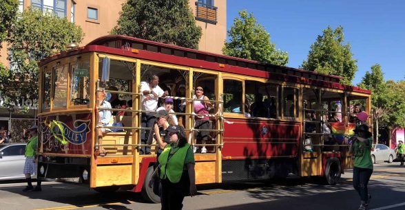A trolley with people on it in rolling through a march.