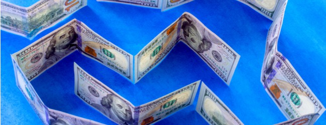 A maze made out of U.S. $100 bills on a blue background.