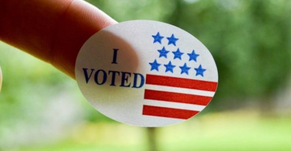 Photo of a person's finger with an "I Voted" sticker stuck to it.