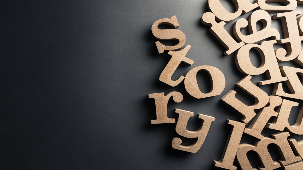 The word story spelled out in wooden letters, surrounded by other randomized wooden letters.