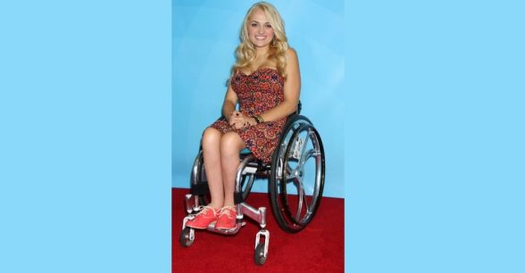 Photo of Ali Stroker, a blonde-haired white woman in a wheelchair.