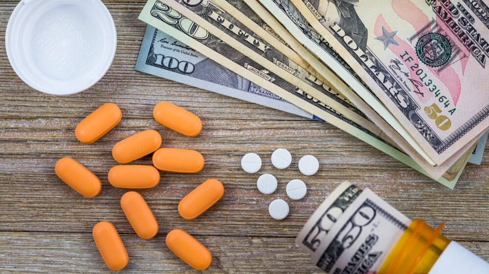A photo of pills and American money, indicating "big pharma."