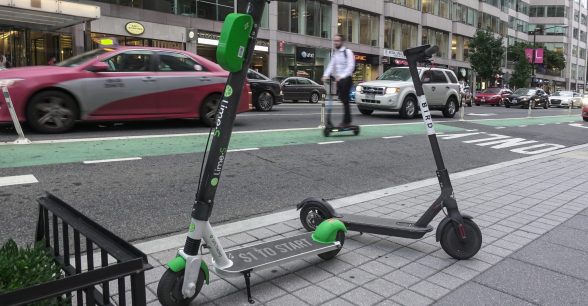 two scooters parked on a sidewalk