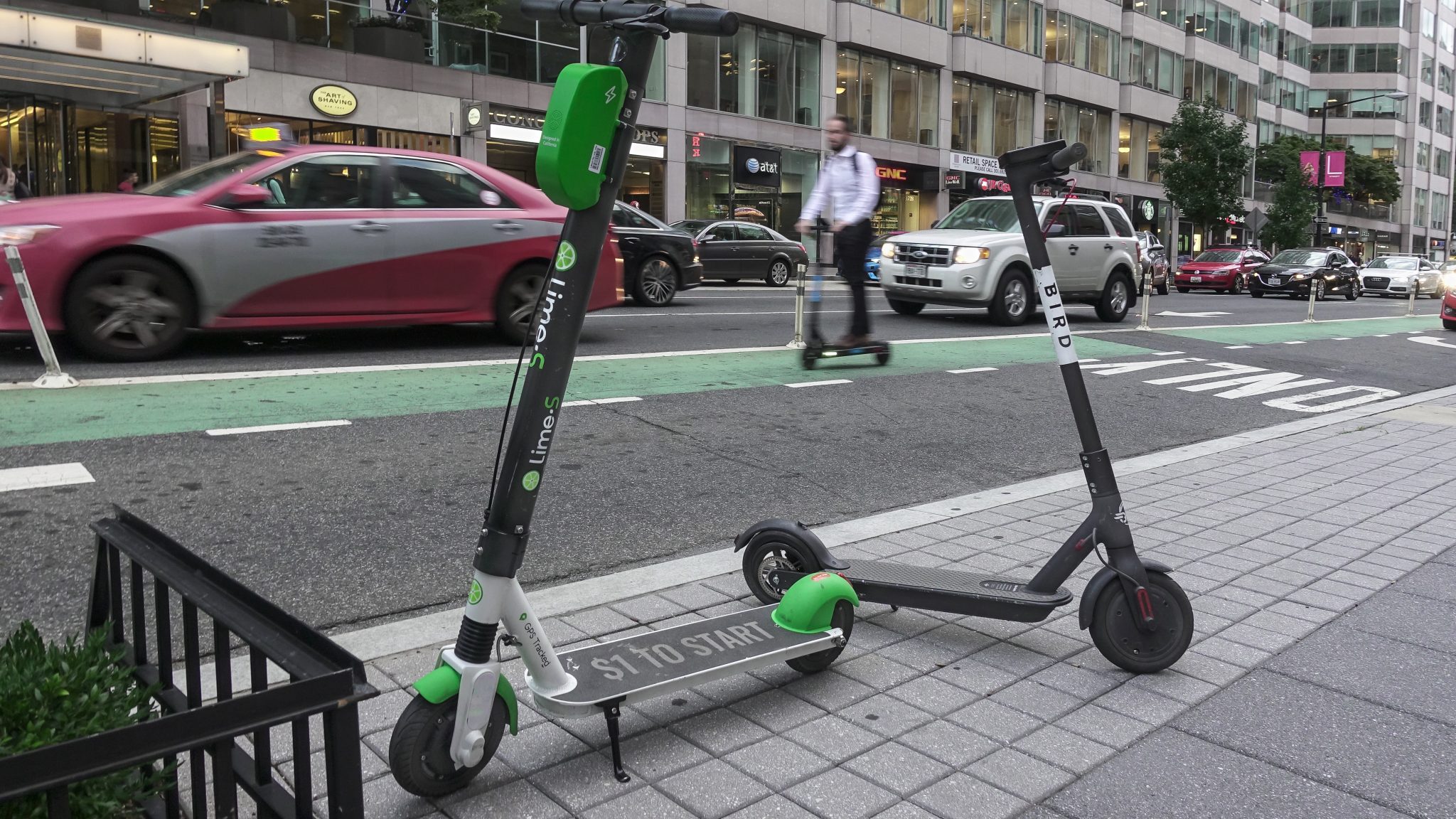 two scooters parked on a sidewalk