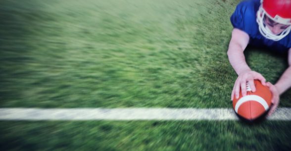 A football player scoring a touchdown