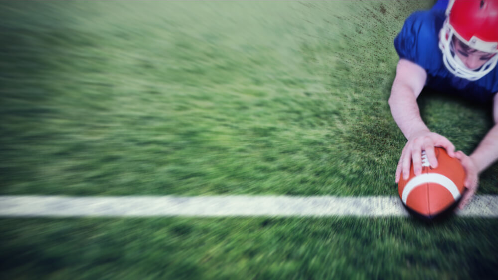 A football player scoring a touchdown
