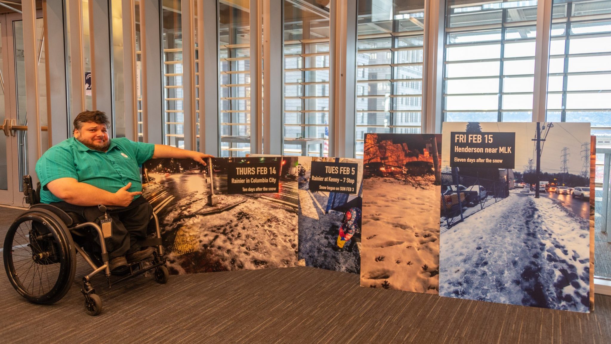 Clark points to giant posters of snow covered streets