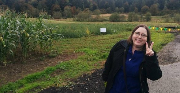 Woman gives peace sign to camera.