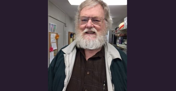 White haired man with beard and glasses