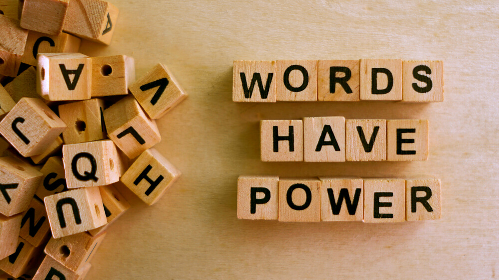 Letter tiles spelling out "words have power."