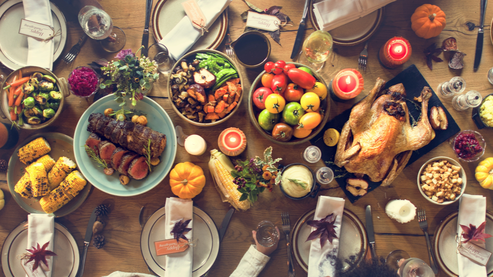 A wooden table filled with Thanksgiving food