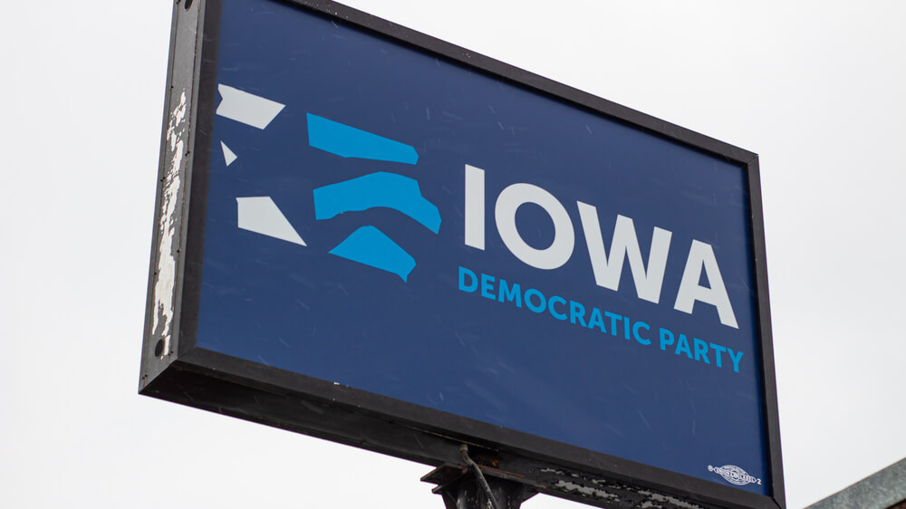 A big blue sign that says "Iowa Democratic Party"