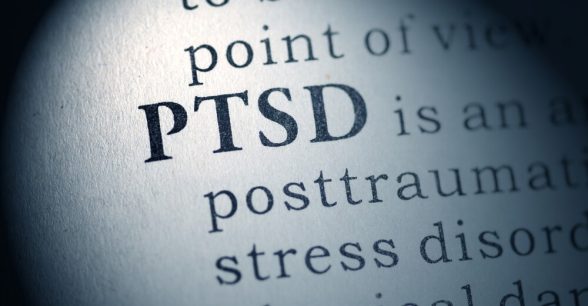 A close-up photo of a page of a book that says "PTSD."