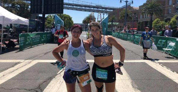 Photo of Amy and friend, both pausing from running.