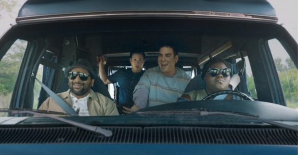 Photo of four people in a car about to embark on a roadtrip.