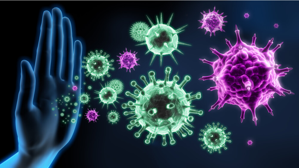 Hand stopping germs from getting closer - a visual concept of immune defense