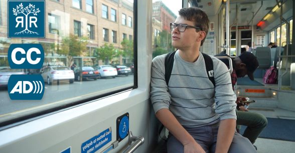 Luke is seated on the bus.