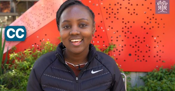 Image of Noela Luka. She's outside and behind her is a triangular shaped figure.