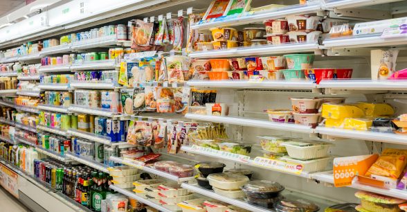 An aisle in a the refrigerated section of a convenience store.