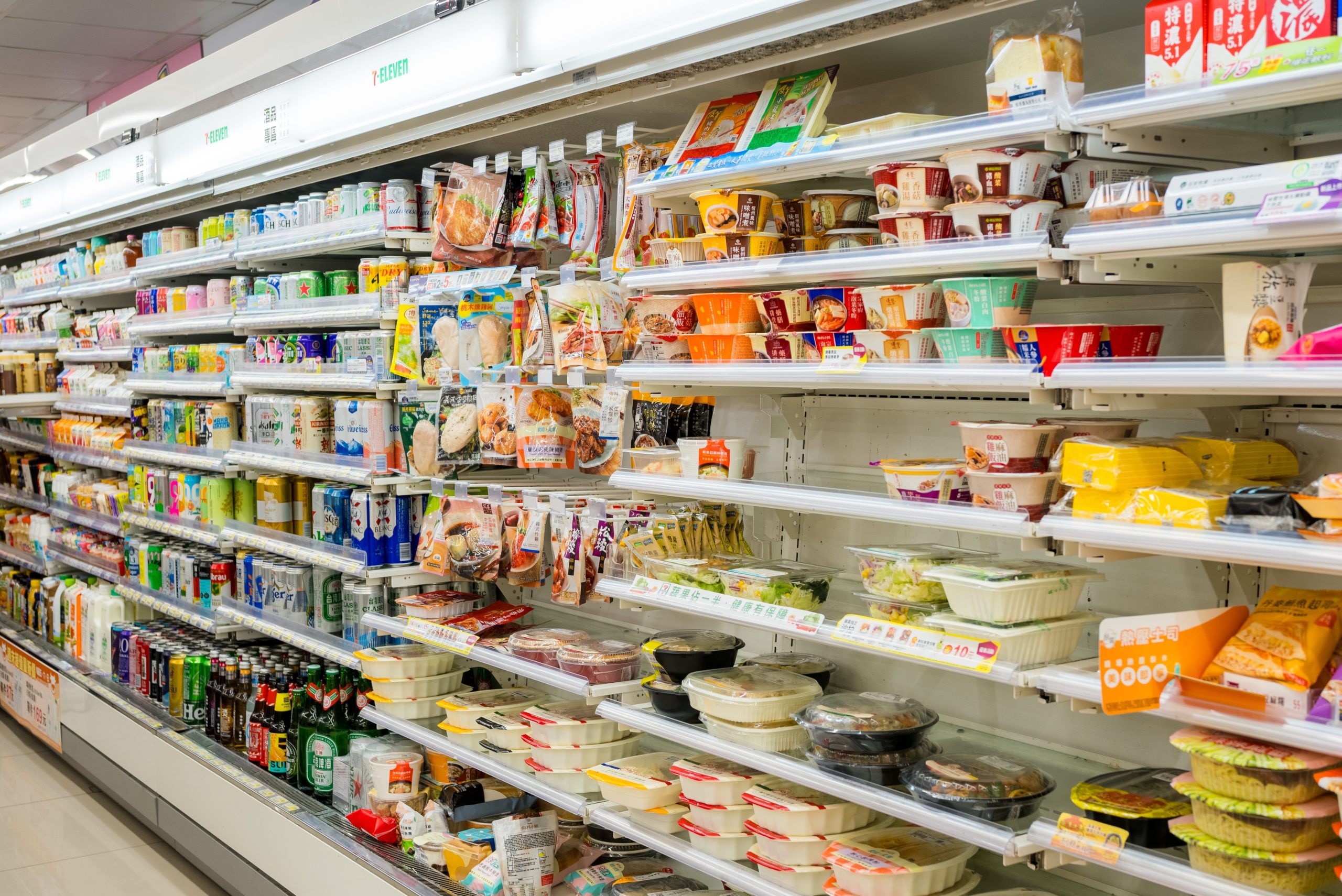 An aisle in a the refrigerated section of a convenience store.