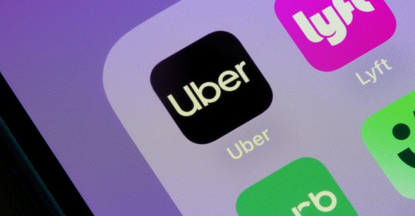 Close up of a phone screen featuring "Uber," "Lyft," and "curb," apps in black, purple, and green squares.
